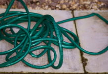 This photo of a garden hose with kinks illustrates the bottlenecks that impede workflow in the business office.