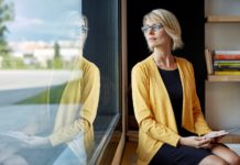 image of business executive looking out a window