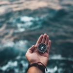 image of man's hand holding compass